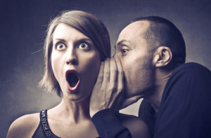 man-telling-a-woman-a-secret-300x197